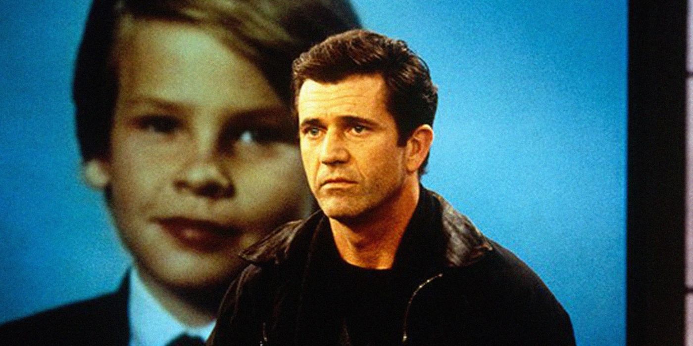 Mel Gibson as Tom looking distraught in front of a large photo of his son in Ransom