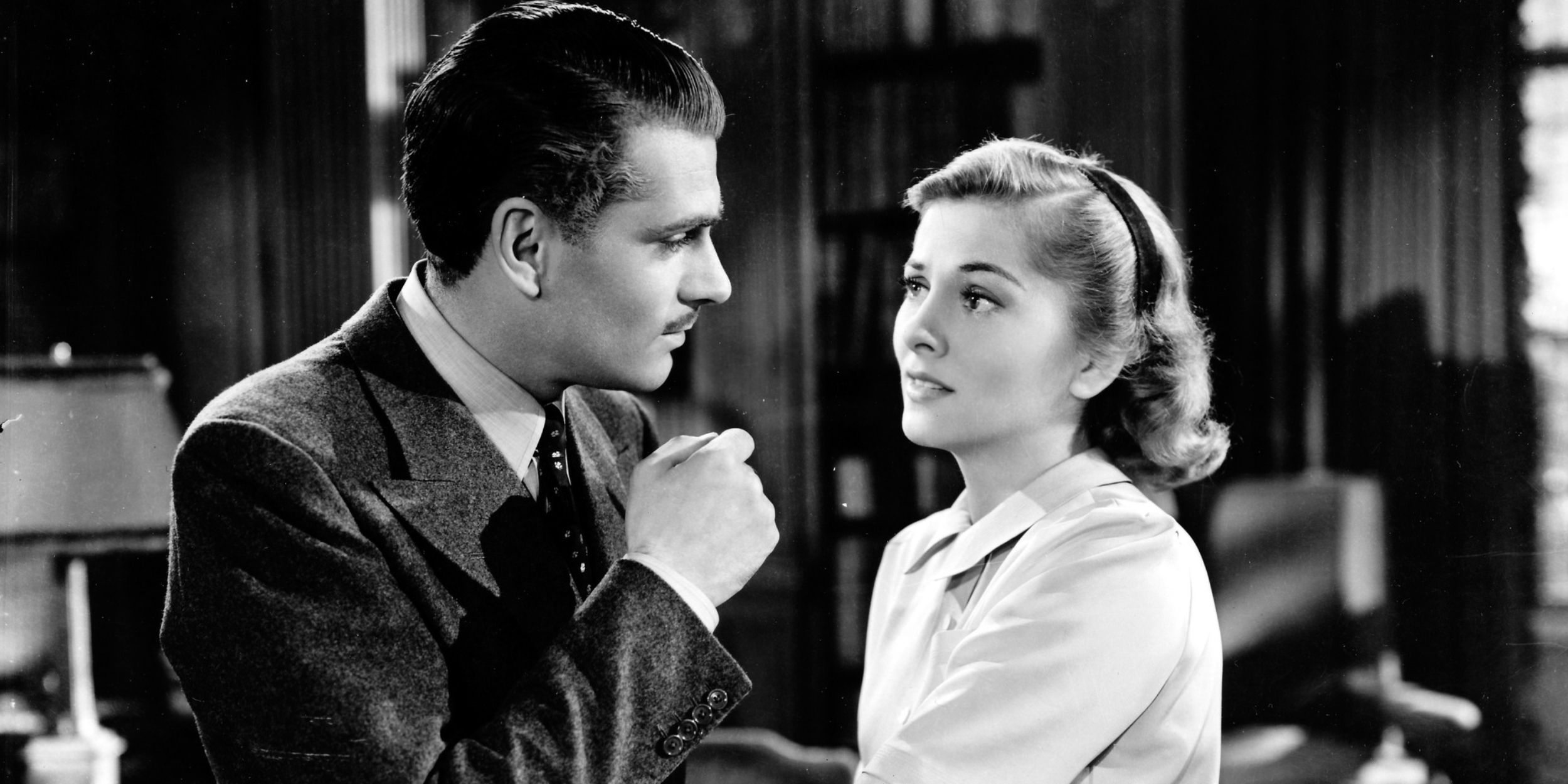 Laurence Olivier and Joan Fontaine looking at each other in Rebecca