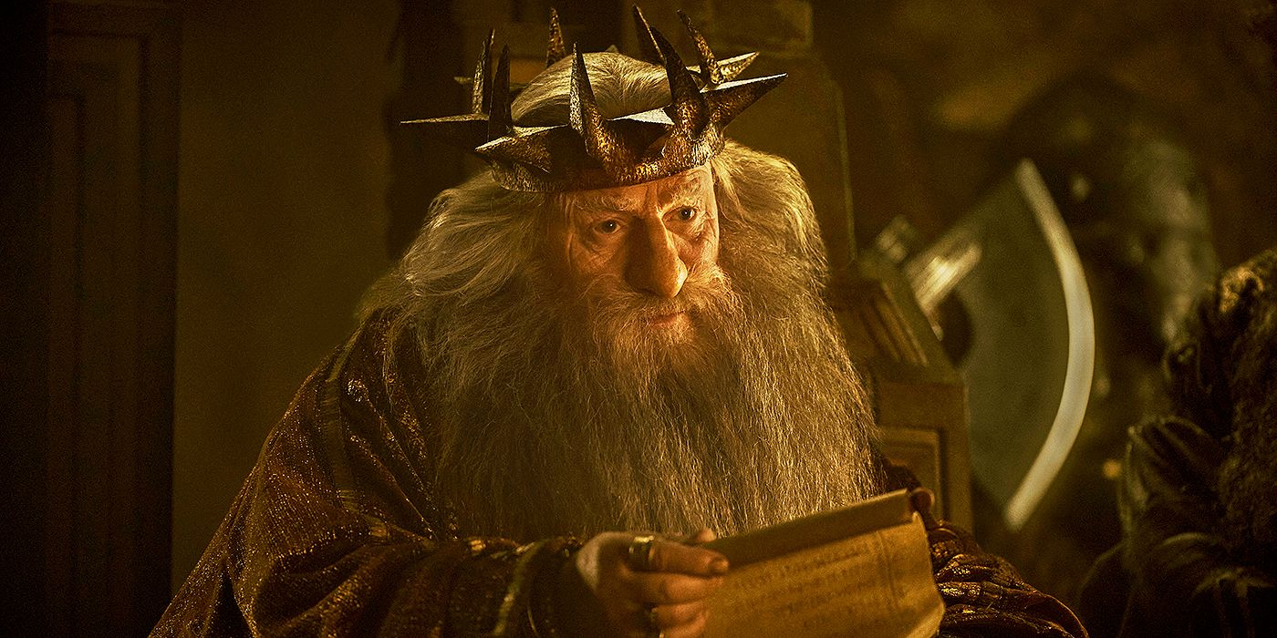 Peter Mullan as King Durin III wearing his crown and reading a scroll in The Lord of the Rings: The Rings of Power Season 2