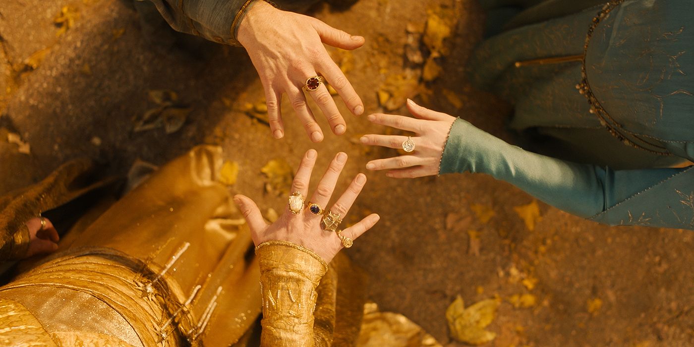 Three elven hands together wearing the rings of power made by Celebrimbor