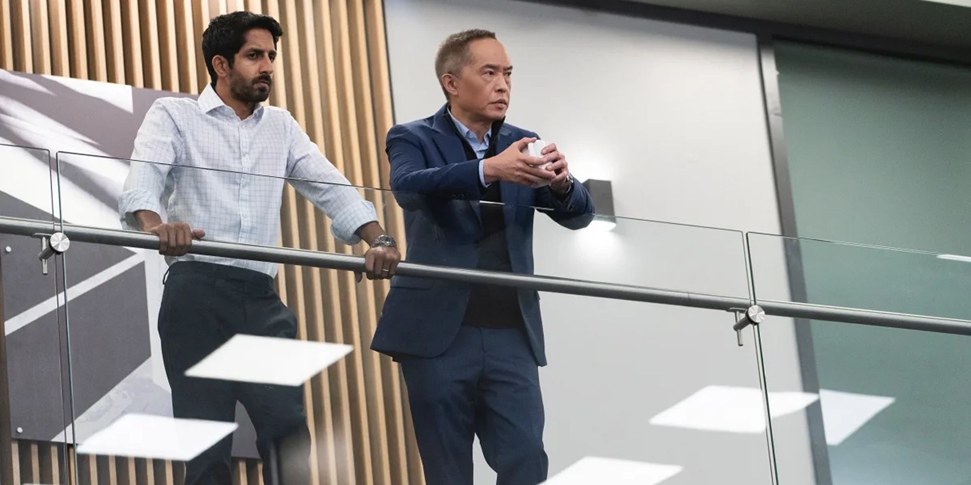 Rishi (Sagar Radia) and Eric (Ken Leung) staring out at the trading floor in Industry Season 3