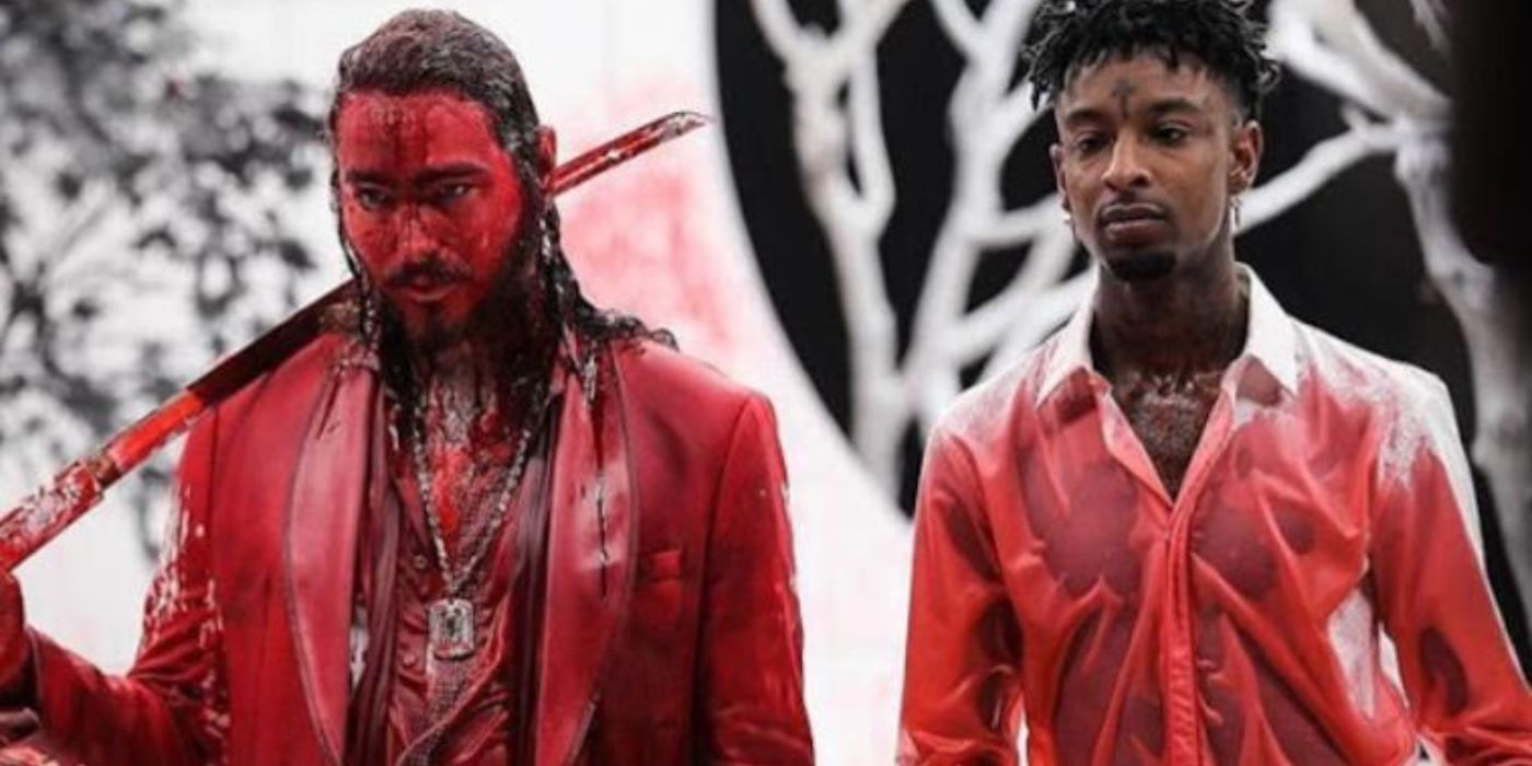 Post Malone (left) holds a katana with 21 Savage (right). Both are covered in blood on the set of the "Rockstar" music video