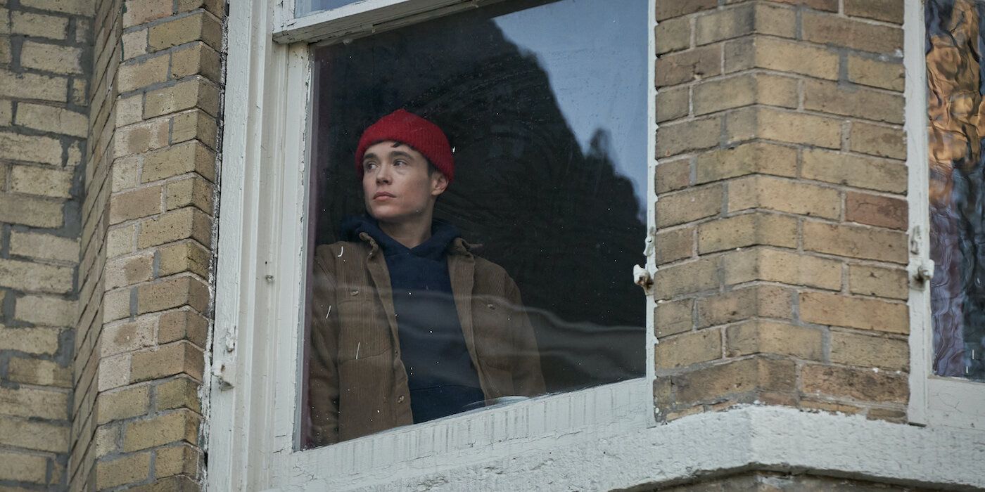 Elliot Page as Sam looks out a window wearing a red hat in Close to You. 