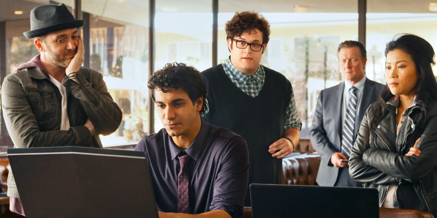 The cast of CBS's Scorpion gathered around Elyes Gabel at a computer