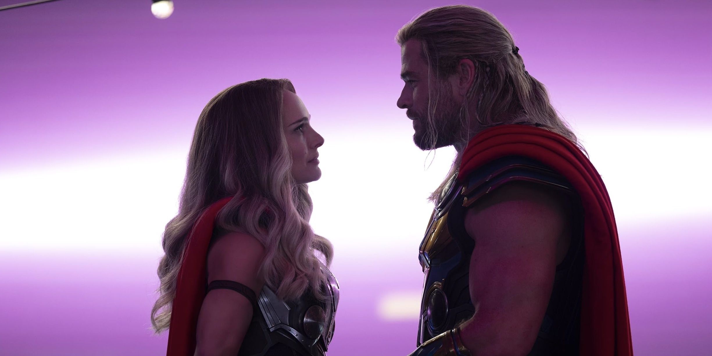 Thor and Jane Foster look into eachothers eyes, surronded by pink