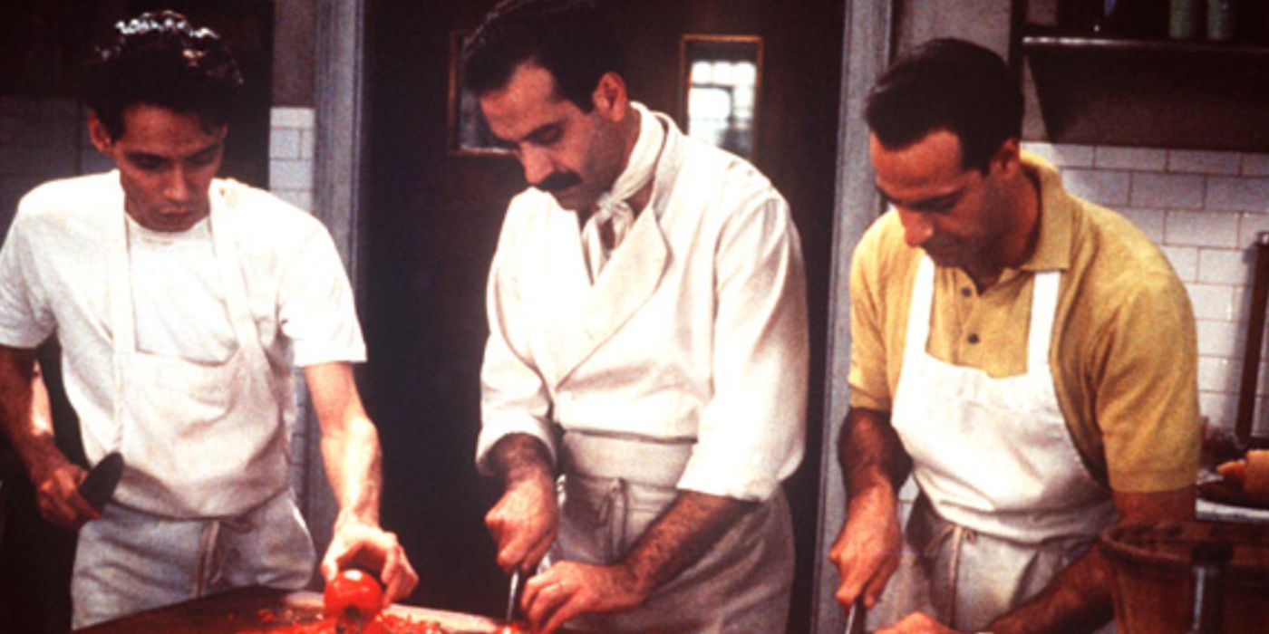 Tony Shalhoub and Stanley Tucci as Primo and Secondo holding knives cooking in the kitchen in 'Big Night'