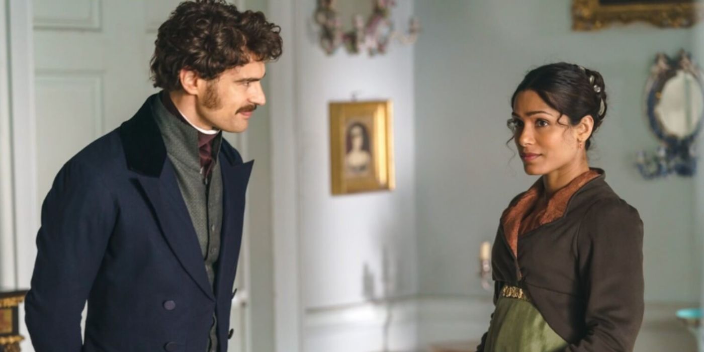 Theo James and Freida Pinto as Henry Ossery and Selina standing in room wearing coats in 'Mr. Malcolm's List'