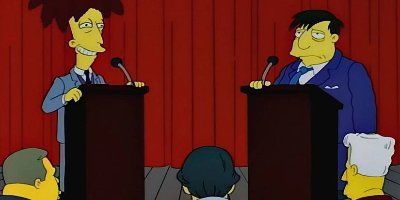 Sideshow Bob and Mayor Quimby behind podiums on stage at a debate on The Simpsons. 