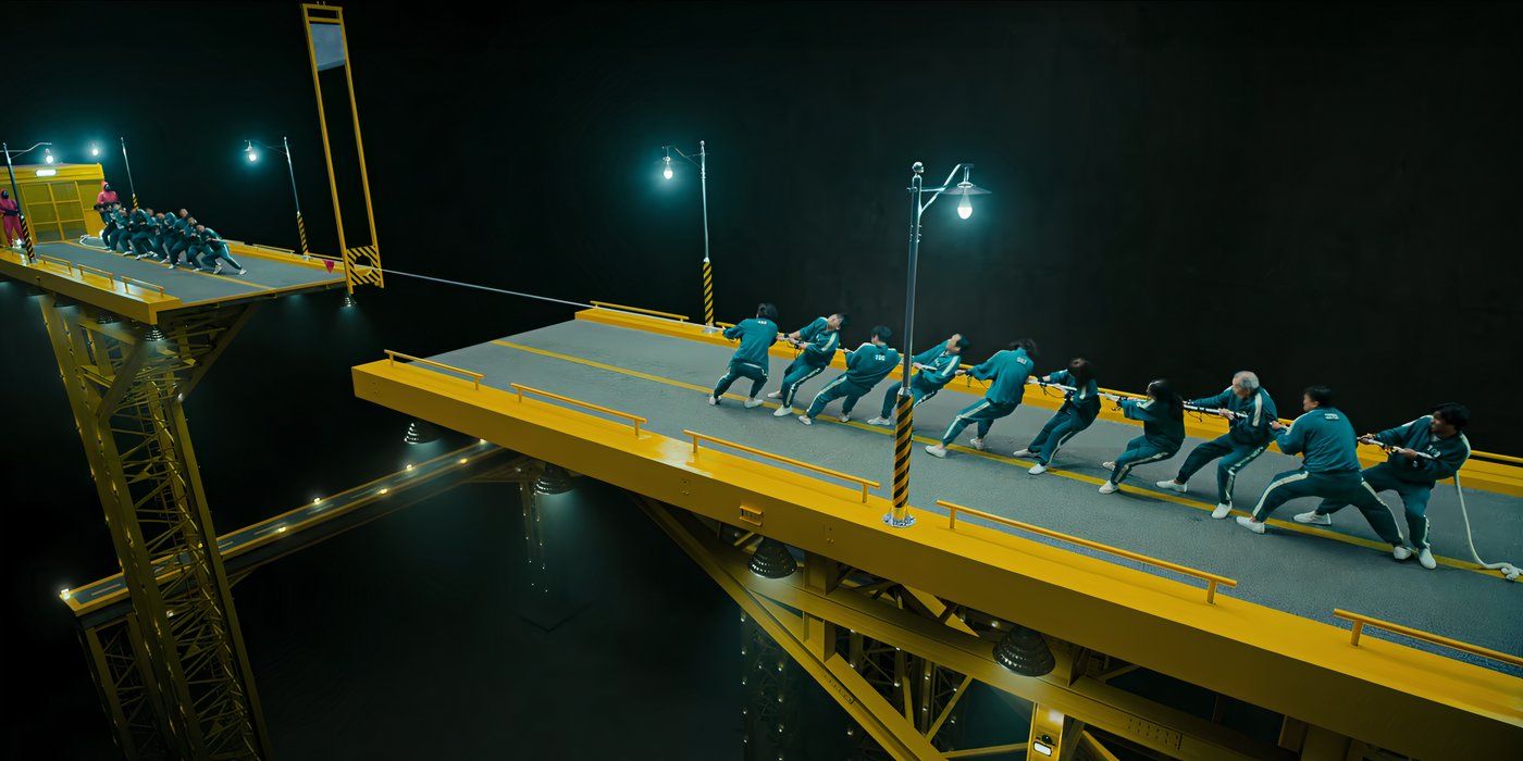 Contestants play tug-of-war on a giant bridge in Squid Game.