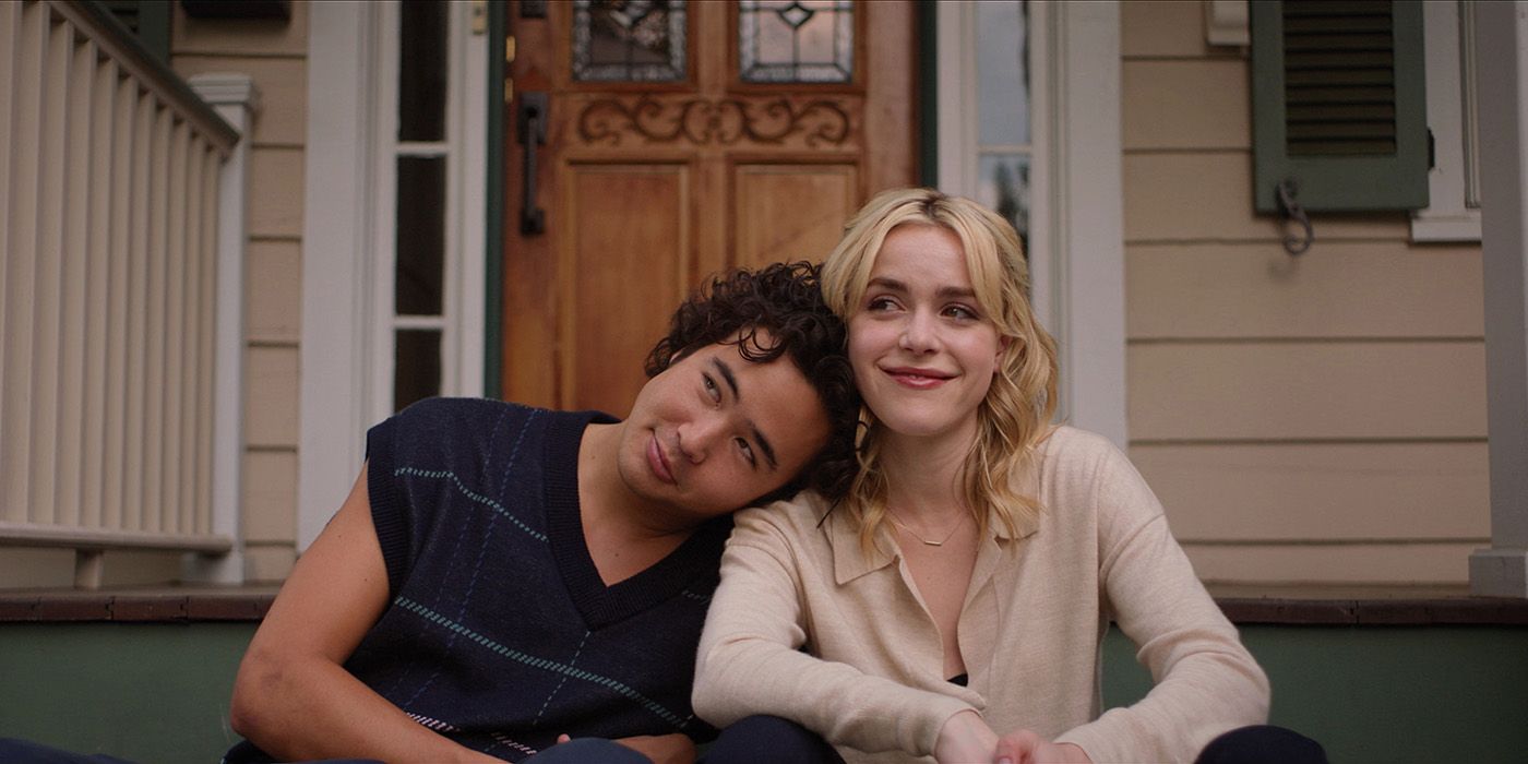 Nico Hiraga leaning on Kiernan Shipka's shoulder on a front porch in Sweethearts