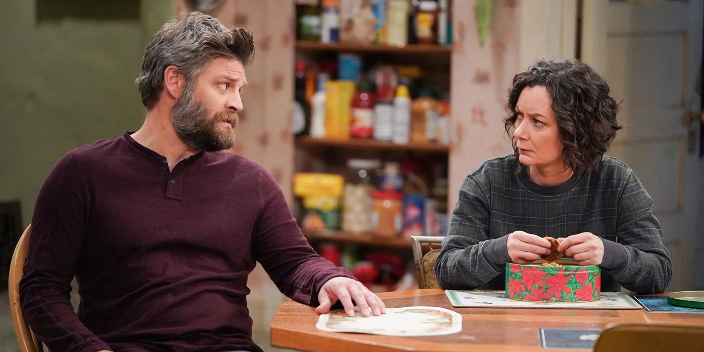 Ben and Darlene sitting at the kitchen table arguing on The Conners