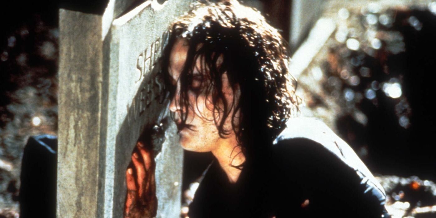 Brandon Lee as Eric Draven hugging a grave in The Crow