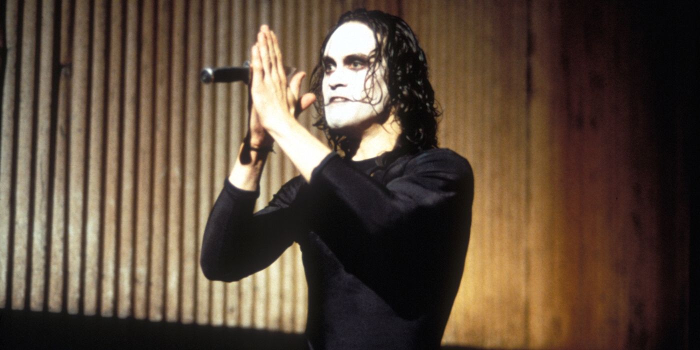 Brandon Lee as Eric Draven, who catches a knife in The Crow