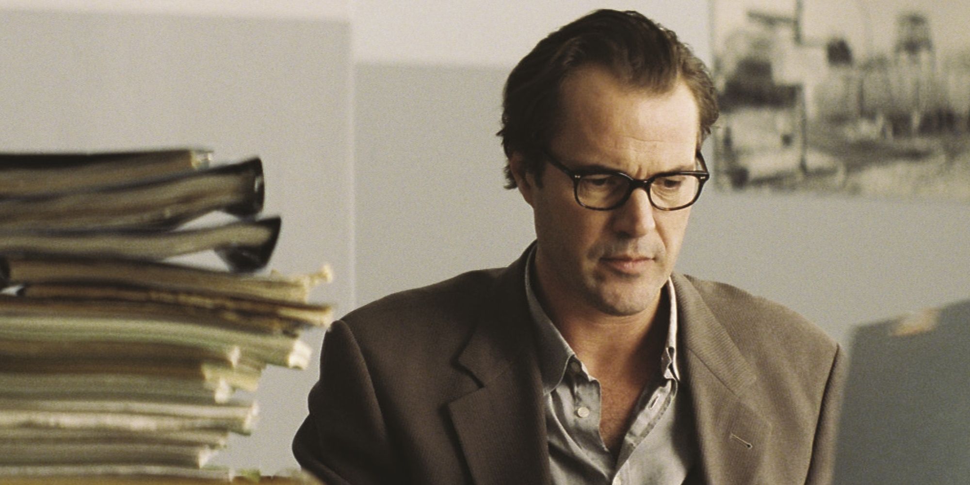 The Lives of Others Sebastian Koch seated besides files