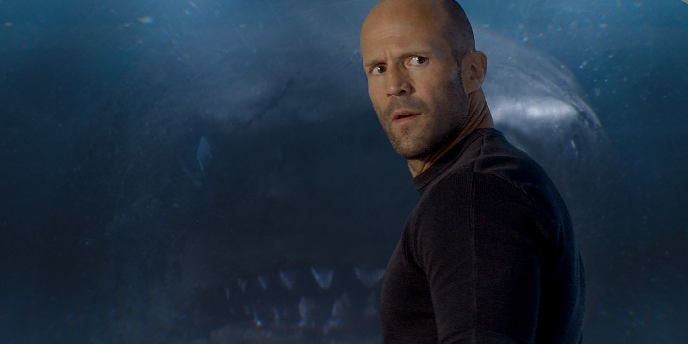 Jason Statham as Jonas Taylor with a shark creeping up behind him in The Meg