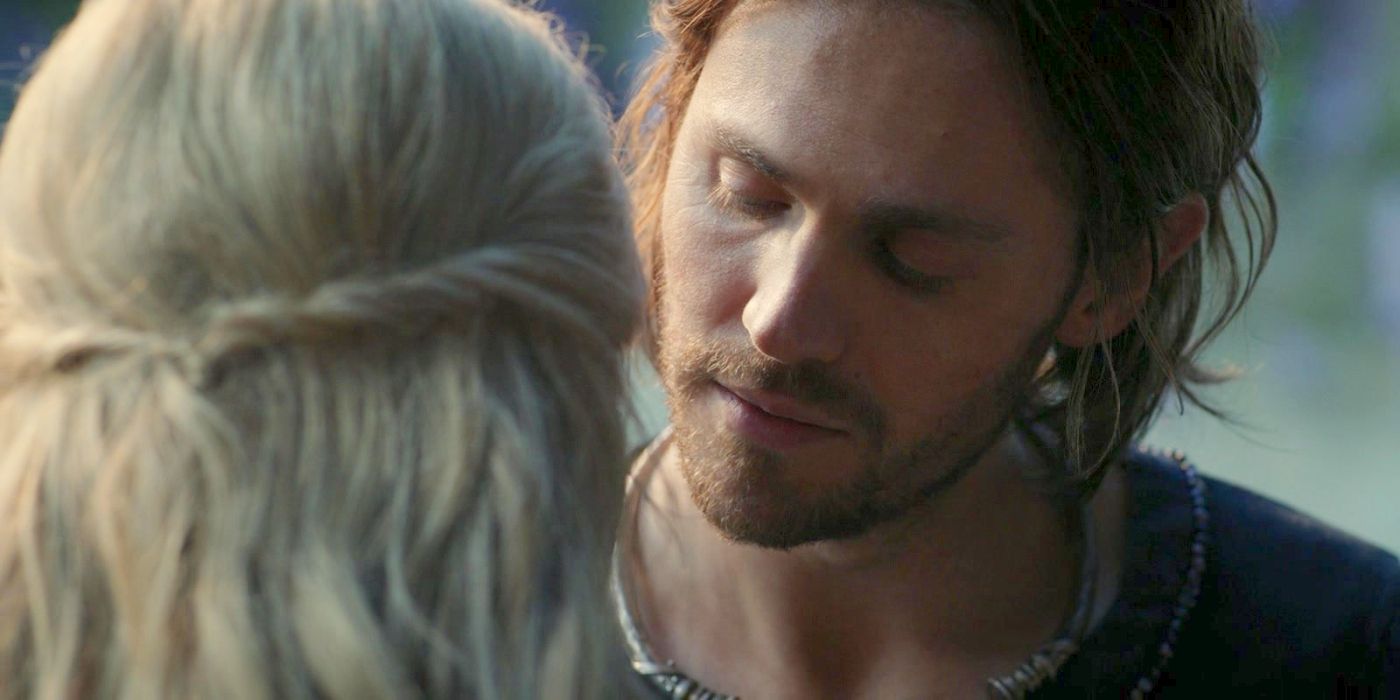 Sauron as Halbrand (Charlie Vickers) lowering his eyes and leaning in close to Galadriel's (Morfydd Clark) face, whose head is seen from behind, in The Rings of Power