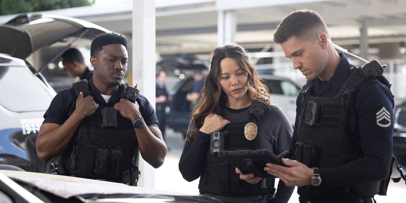 Tru Valentino, Eric Winter, and Melissa O'Neil stand prepping for a case in their uniforms