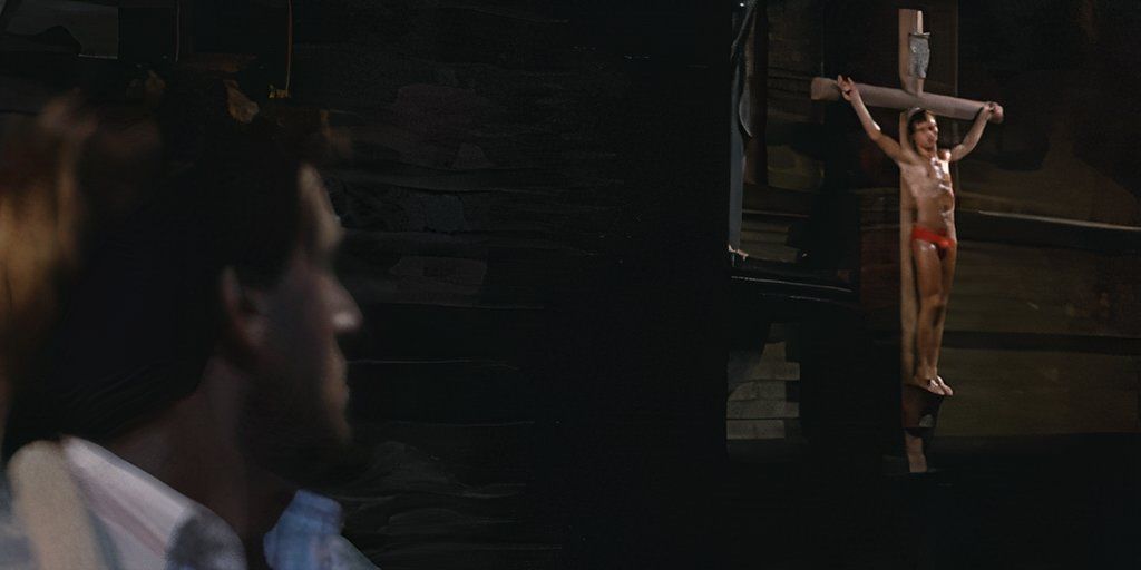 Gerard, played by actor Jeroen Krabbé, looks up at a crucifix hanging on his wall in The 4th Man.