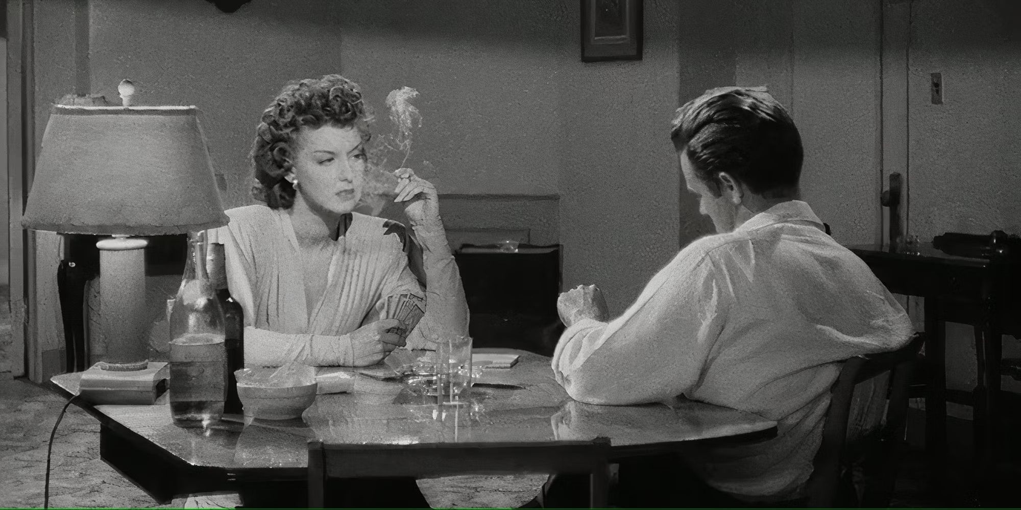 Tom Neal and Ann Savage having a drink together in Detour (1945)