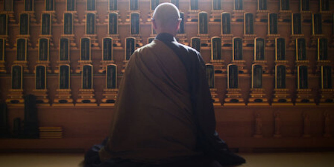 A buddhist priest kneels in front of an altar in 'Unsolved Mysteries" 