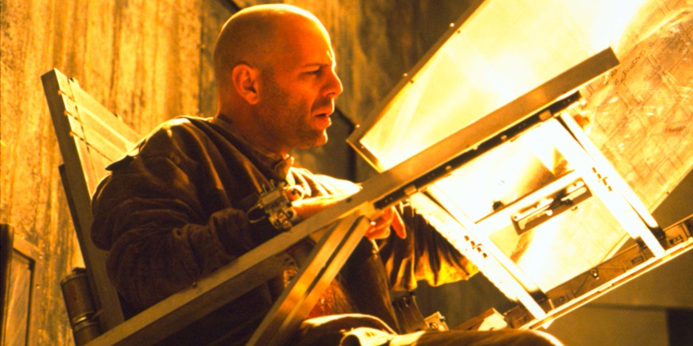 Bruce Willis as James Cole looking at blueprints in 12 Monkeys