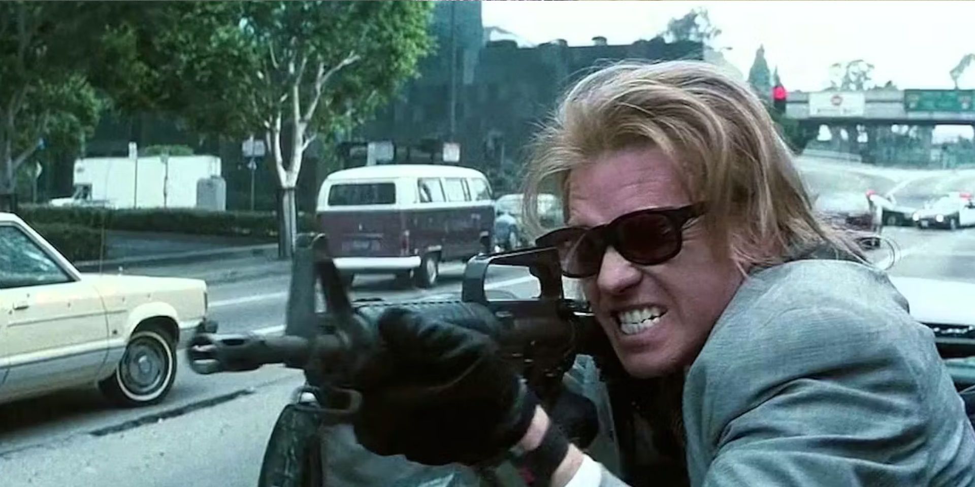 Val Kilmer fires a rifle during a shootout in Michael Mann's 'Heat'