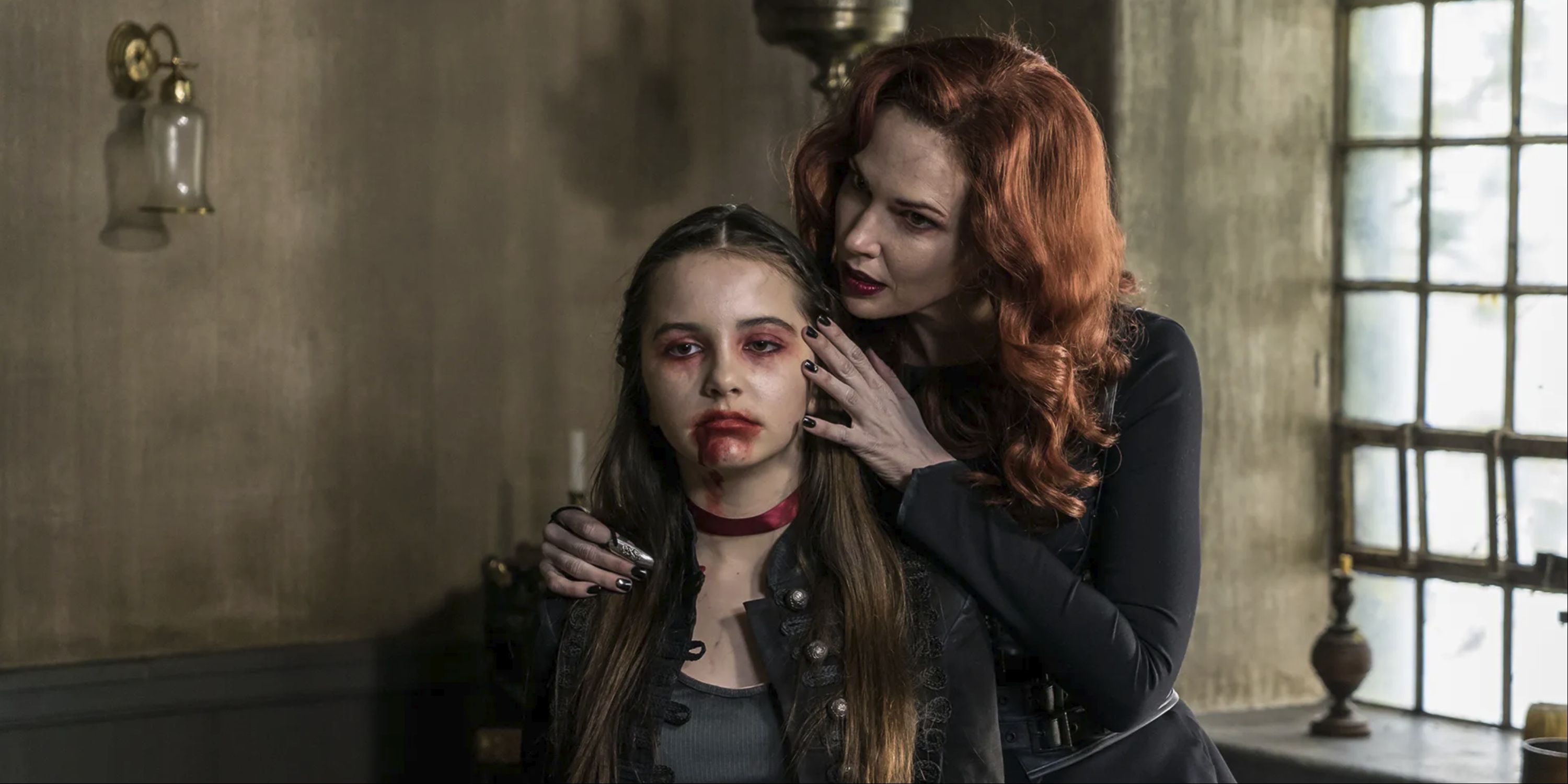 A woman holding a girl who has blood on her face in Van Helsing