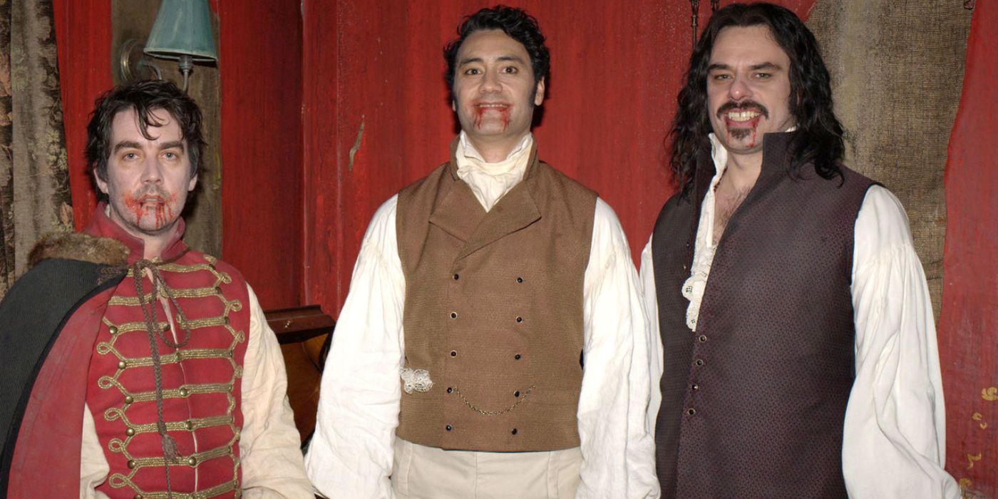 Taika Waititi, Jemaine Clement, and Jonathan Brugh smile with blood on their chins in?What We Do in The Shadows