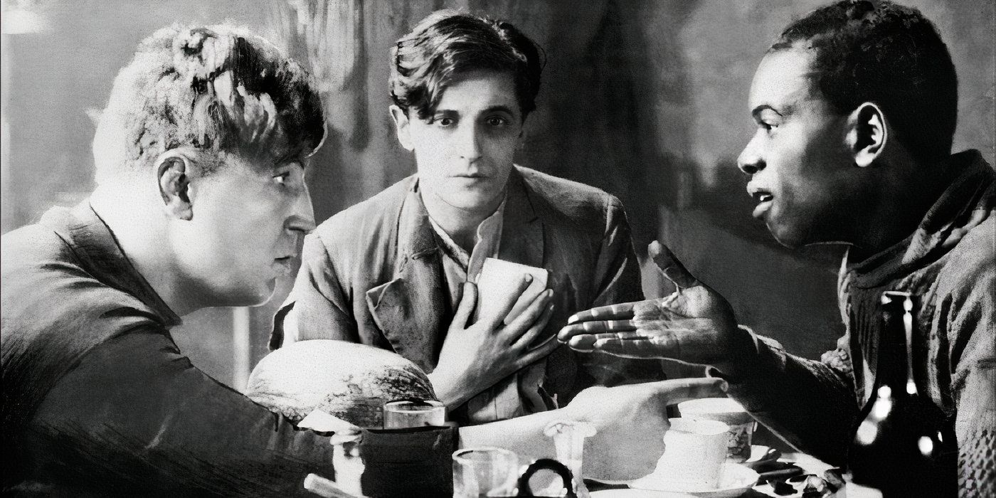 Ivor Novello as Roddy Berwick sharing a meagre meal with two other men in Hitchcock's When the Boys Leave Home (also known as Downhill) 