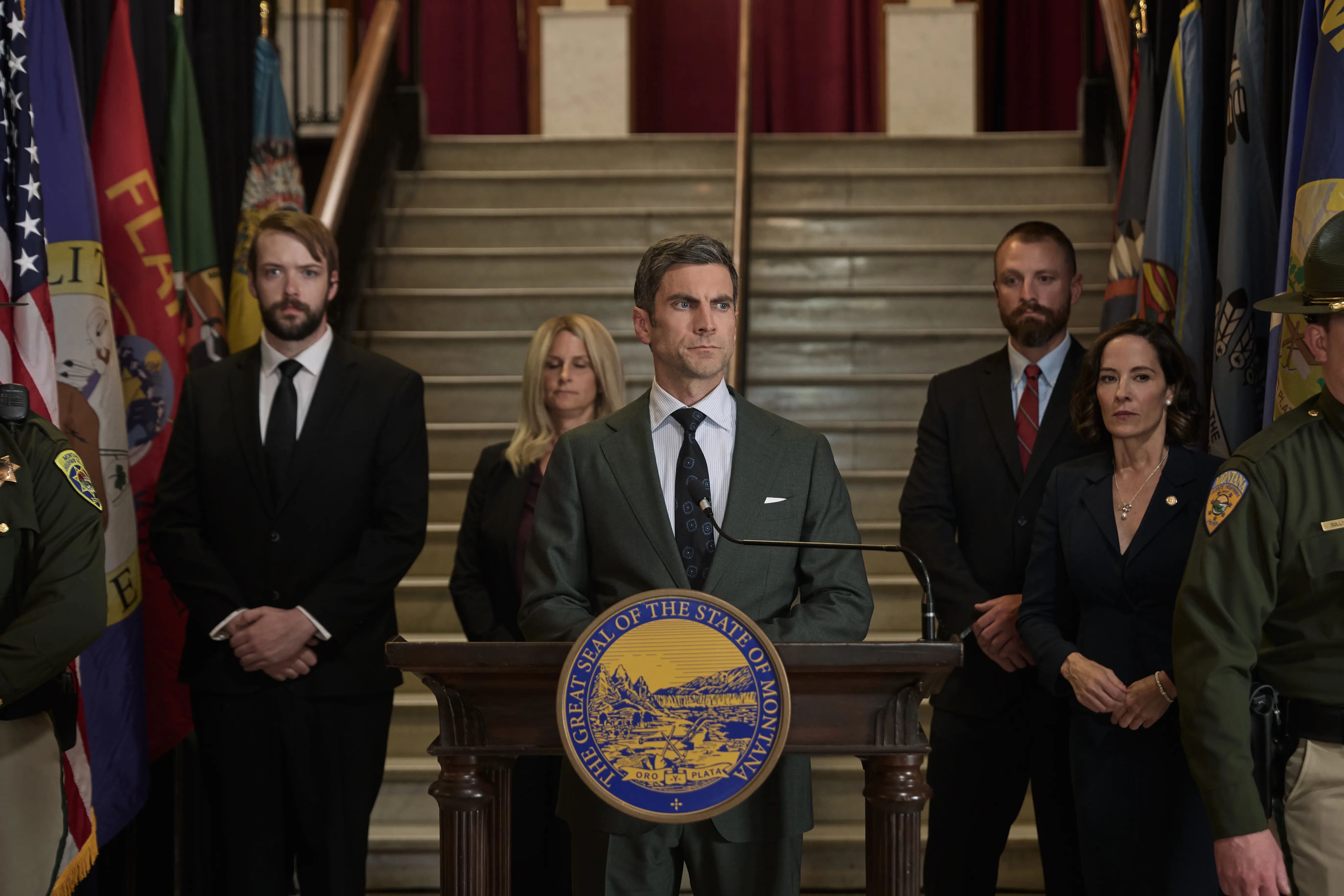 Wes Bently speaking behind a podium in Yellowstone Season 5