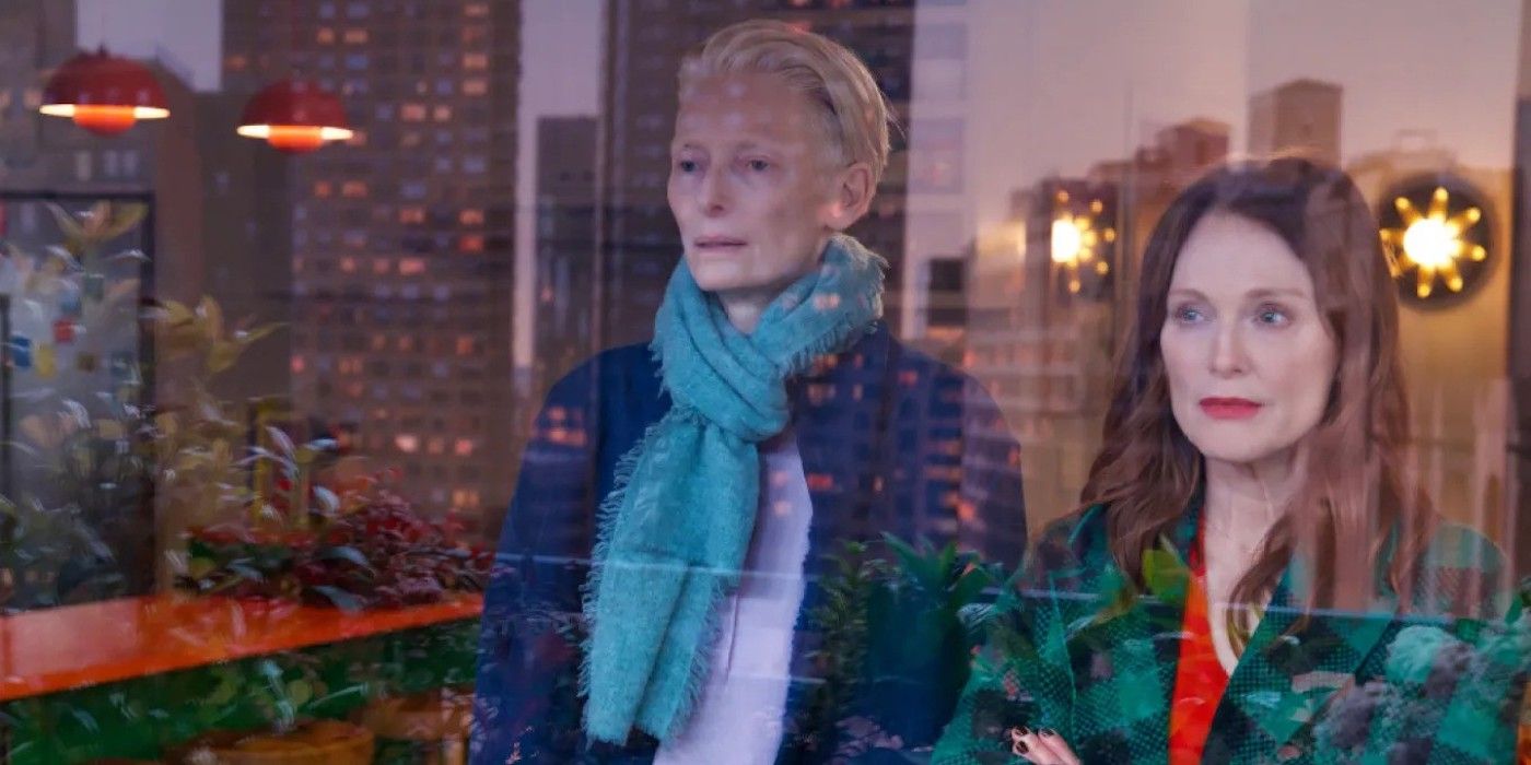 Julianne Moore and Tilda Swinton stare out a window in The Room Next Door. 