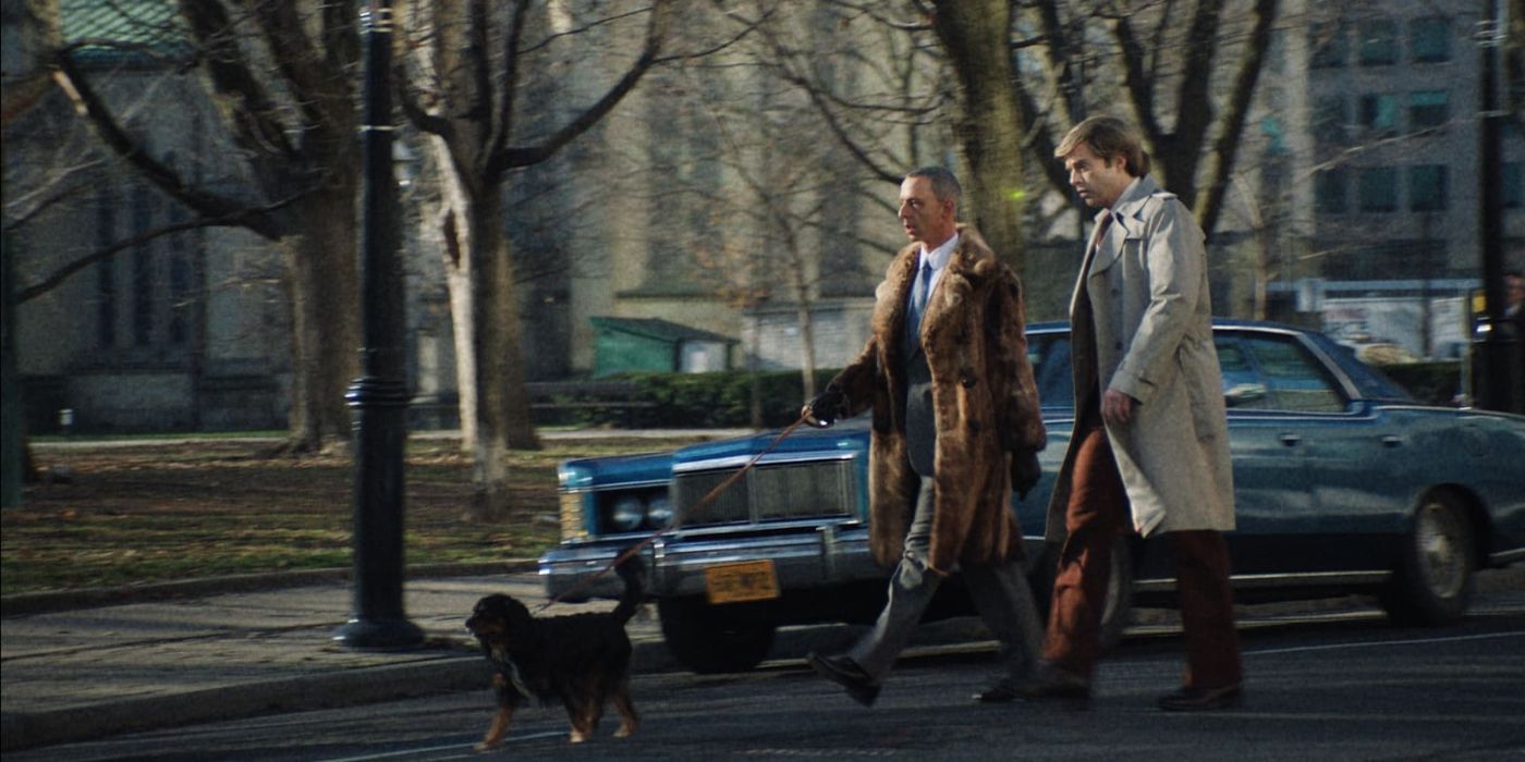 Sebastian Stan as Donald Trump walks down the street with Roy Cohn, played by Jeremy Strong, and his dog.