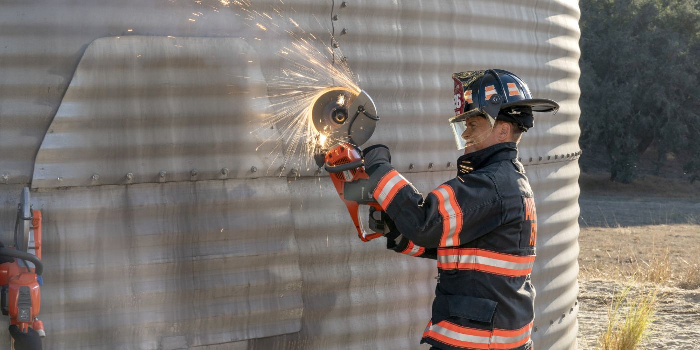 A man in a firefighter uniform holds a circular saw against a metal bin and sparks fly in 9-1-1: Lone Star.