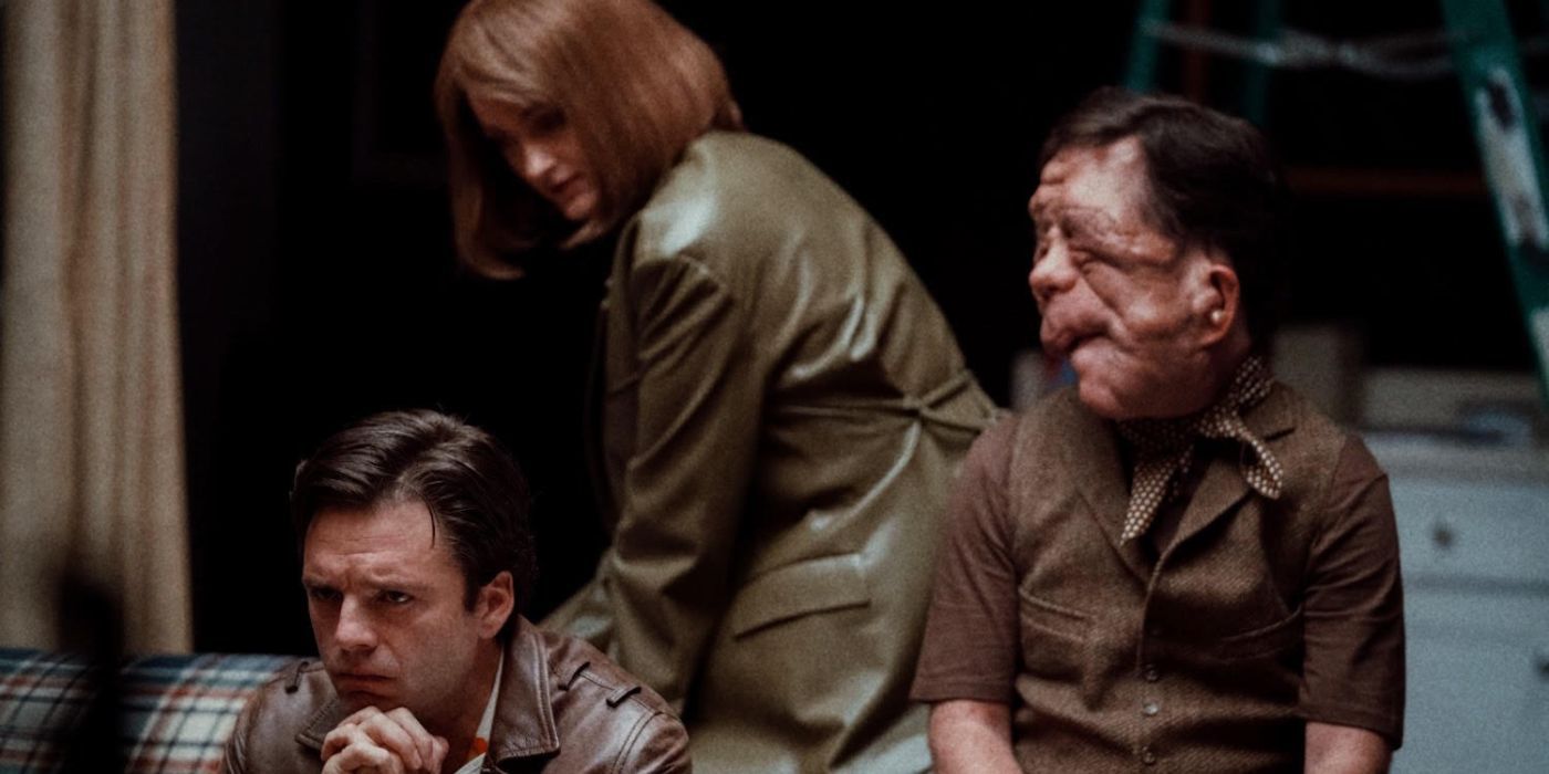 Renate Reinsve, Adam Pearson, and Sebastian Stan posing in an apartment in a scene from A Different Man.