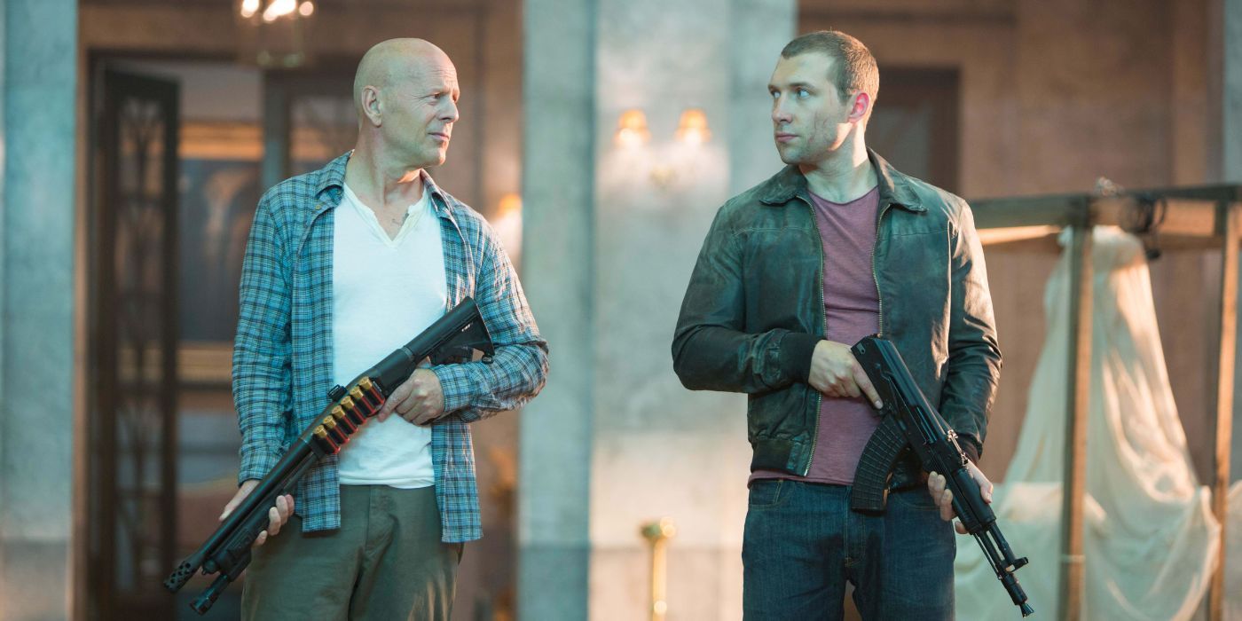 Bruce Willis and Jai Courtney holding rifles as John and Jack McClane in A Good Day to Die Hard.