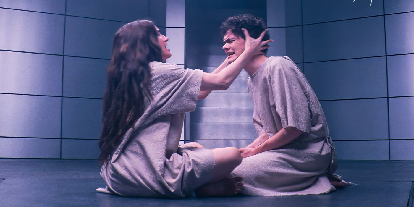 Kathryn Hahn with her hands on either side of Joe Locke&rsquo;s head sitting on the ground together