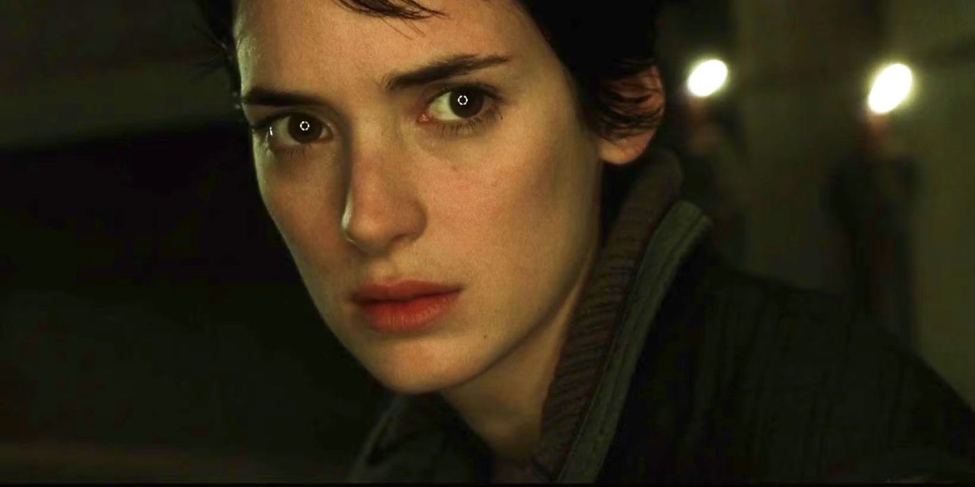 A close up of Call (Winona Ryder) looking somber and slightly toward the right at something offscreen in Alien: Resurrection