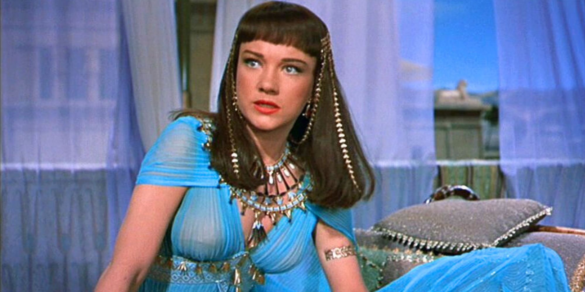 Anne Baxter on a sofa looking distressed in The Ten Commandments (1956)