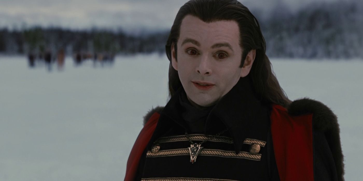 Aro standing in the snow talking to someone off-camera in Breaking Dawn