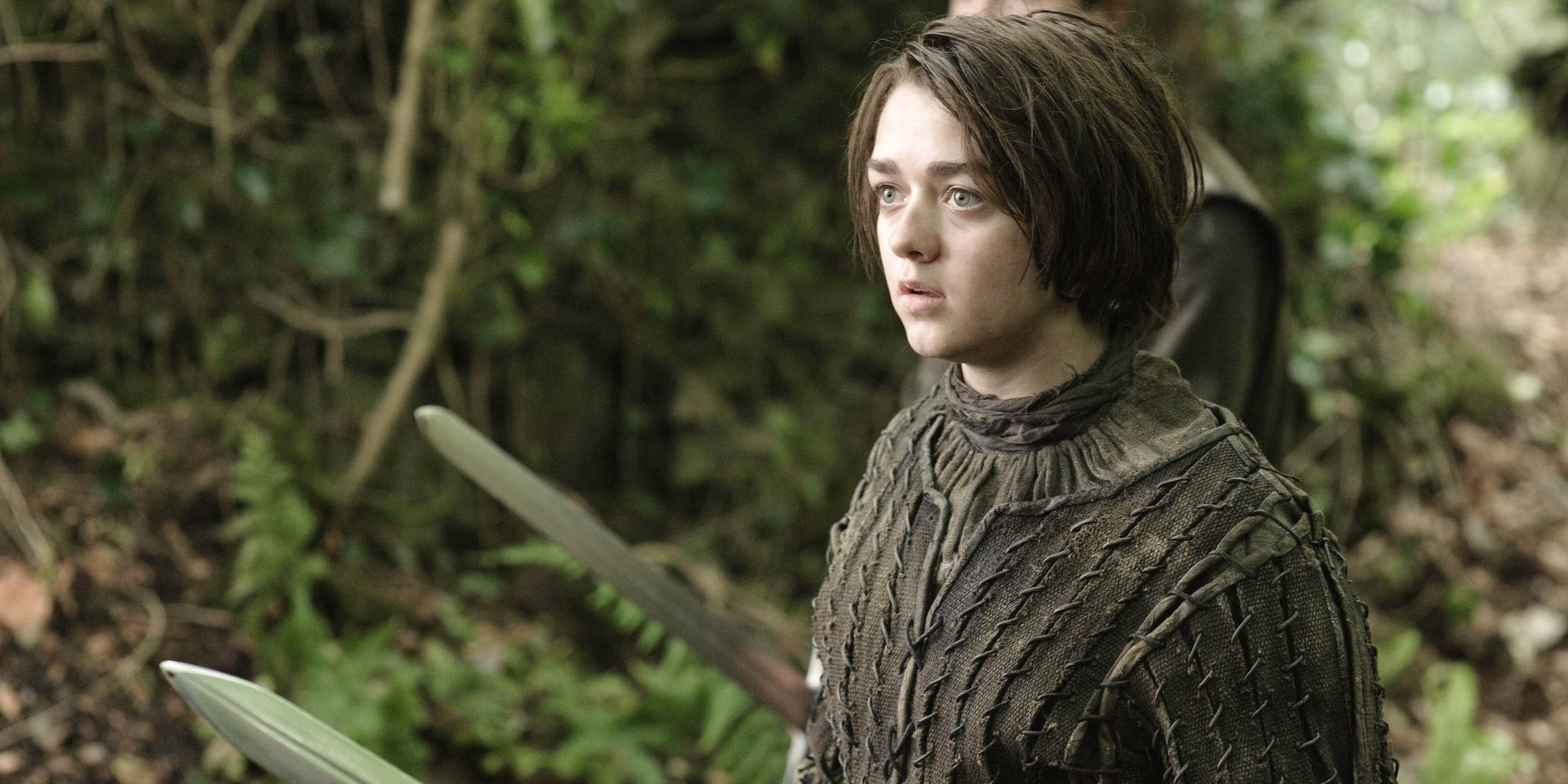 Arya Stark (Maisie Williams) in the woods in 'Game of Thrones'.