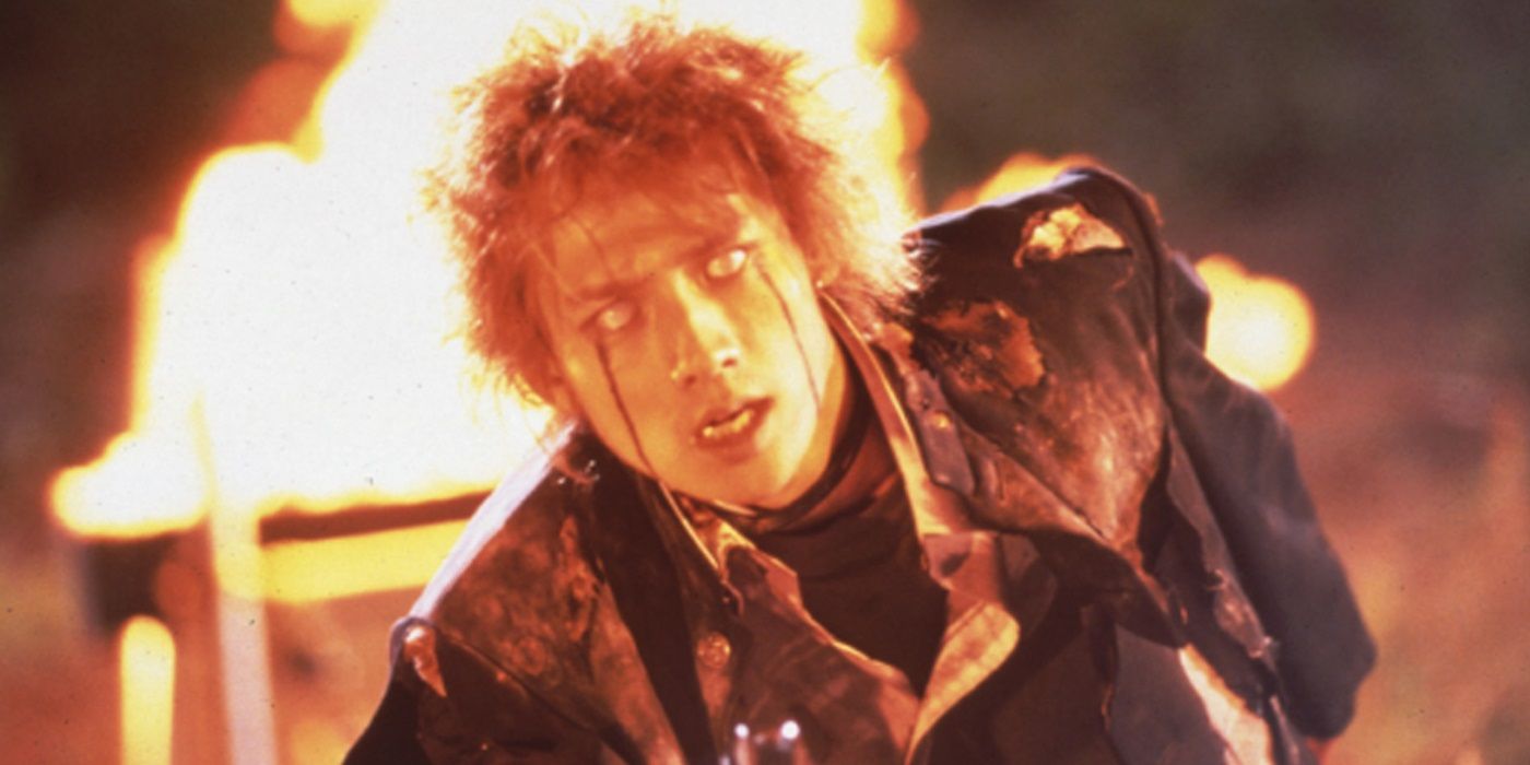 Masanobu Andō as Kazuo Kiriyama walking away from a burning building in Battle Royale