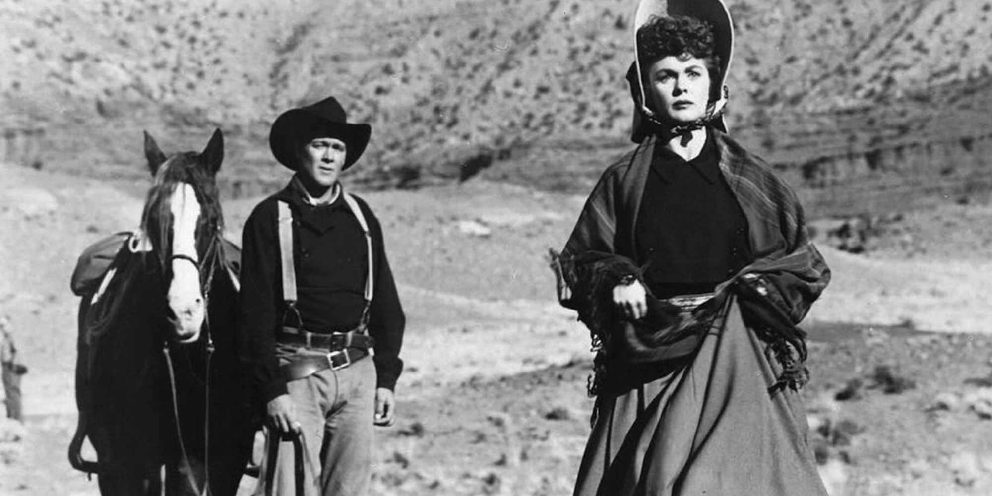 Ben Johnson walking with a horse behind Joanne Dru in Wagon Master (1950)