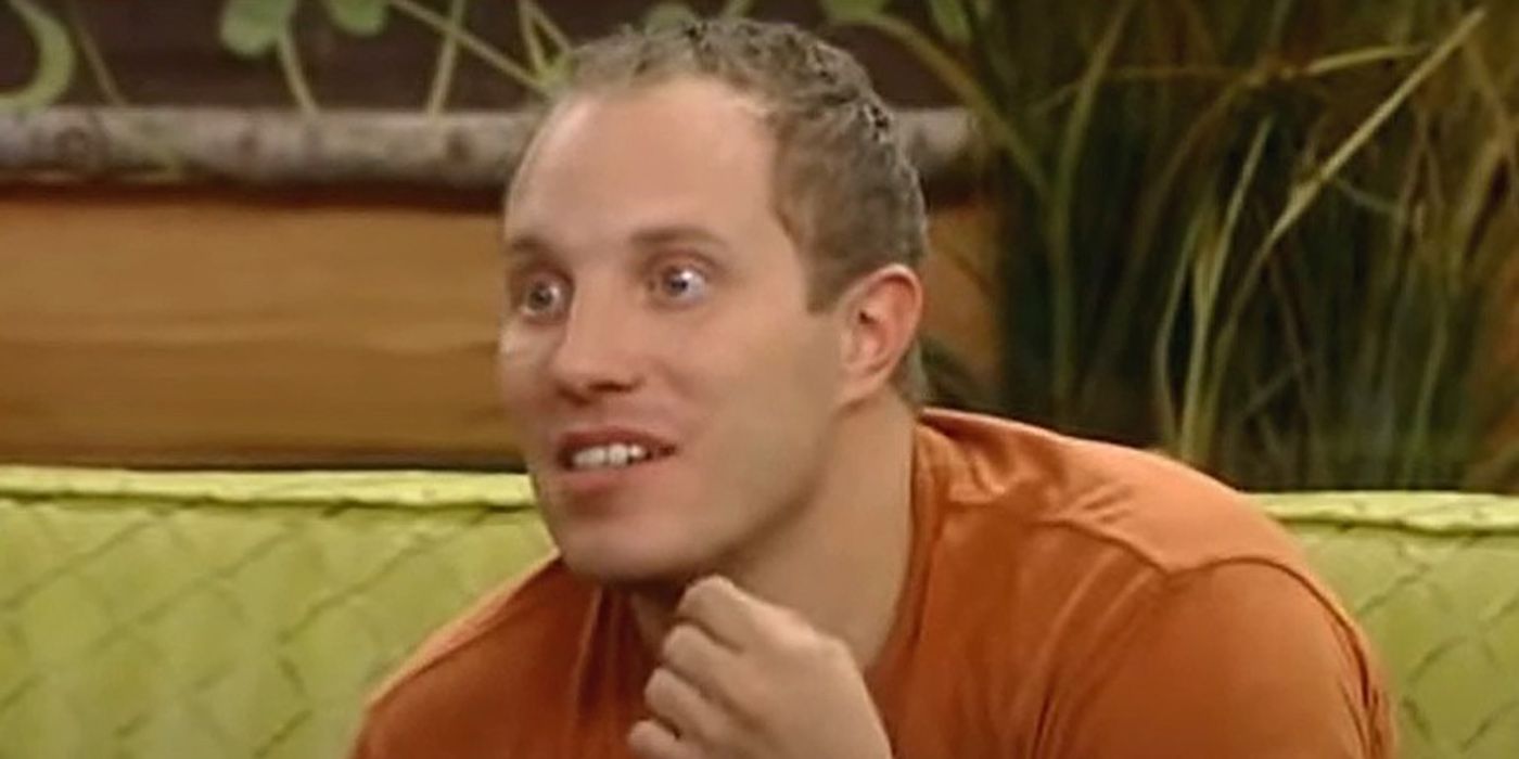 Adam Jasinski from Big Brother sitting on the couch with his eyes wide open.