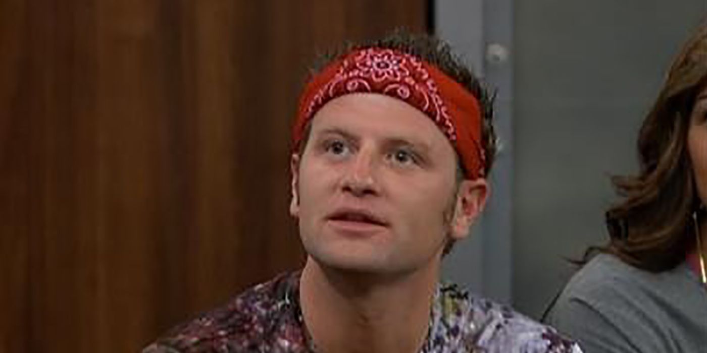 Judd from Big Brother looking up with a red bandana on his head.