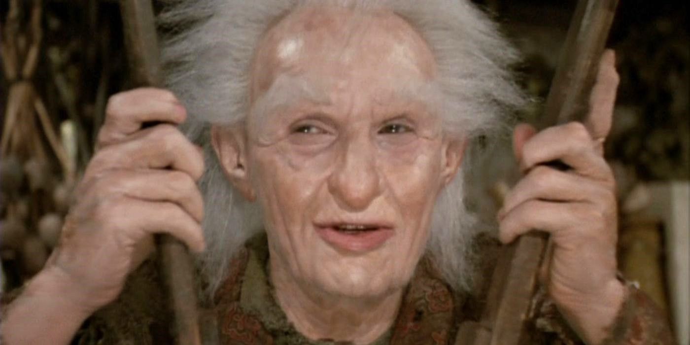 Billy Crystal as Miracle Max holds bellows and looks off camera in The Princess Bride.