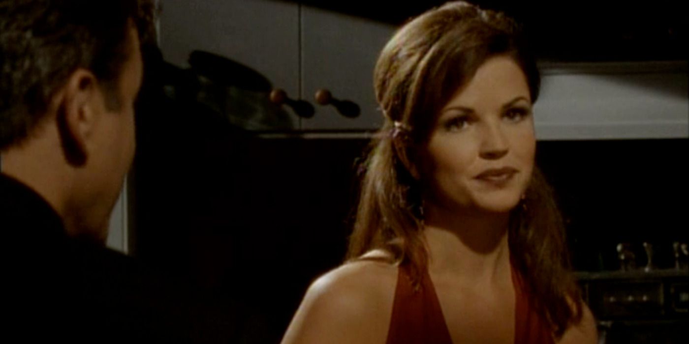 Michelle Lintel wearing a red halter top staring off to the side in Black Scorpion