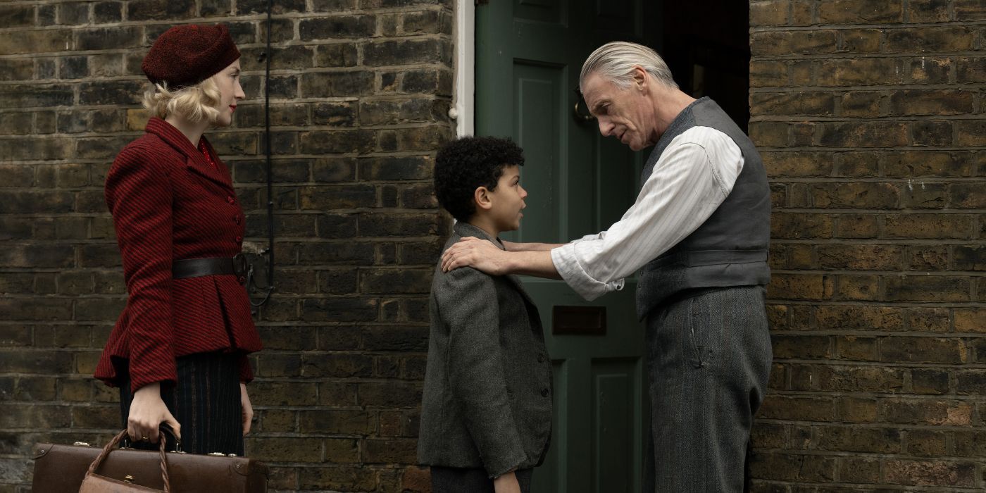 Saoirse Ronan holding a brief case by a doorway as Paul Weller puts his hand on Elliott Heffernan's shoulder in Blitz.