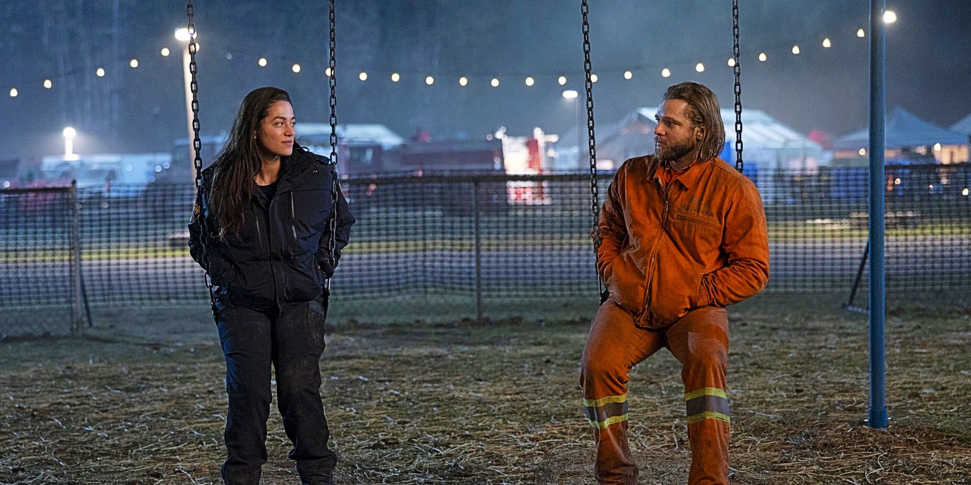 Gabriela Perez (Stephanie Arcila) & Bode Leone (Max Thieriot) sitting on swings together in Fire Country.