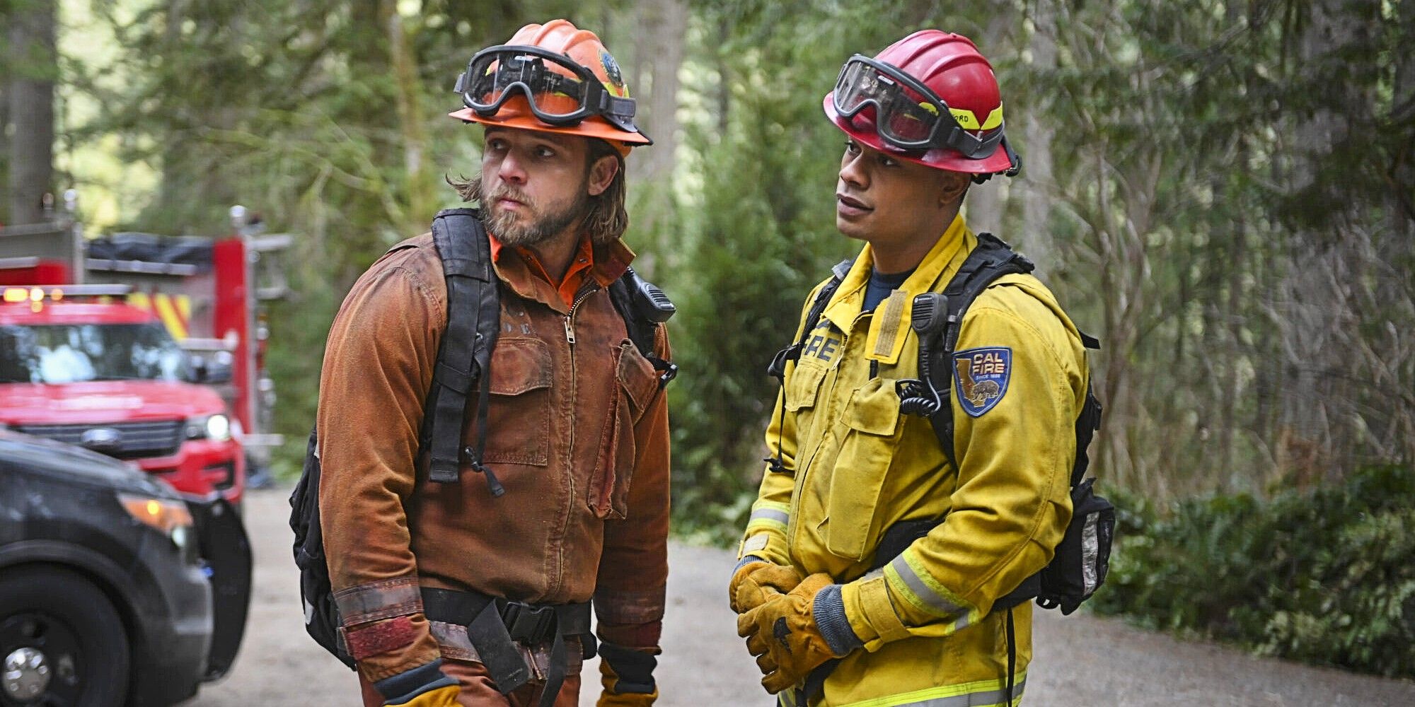 Bode Leone and Jake Crawford together standing at work in their respective uniforms in Fire Country.