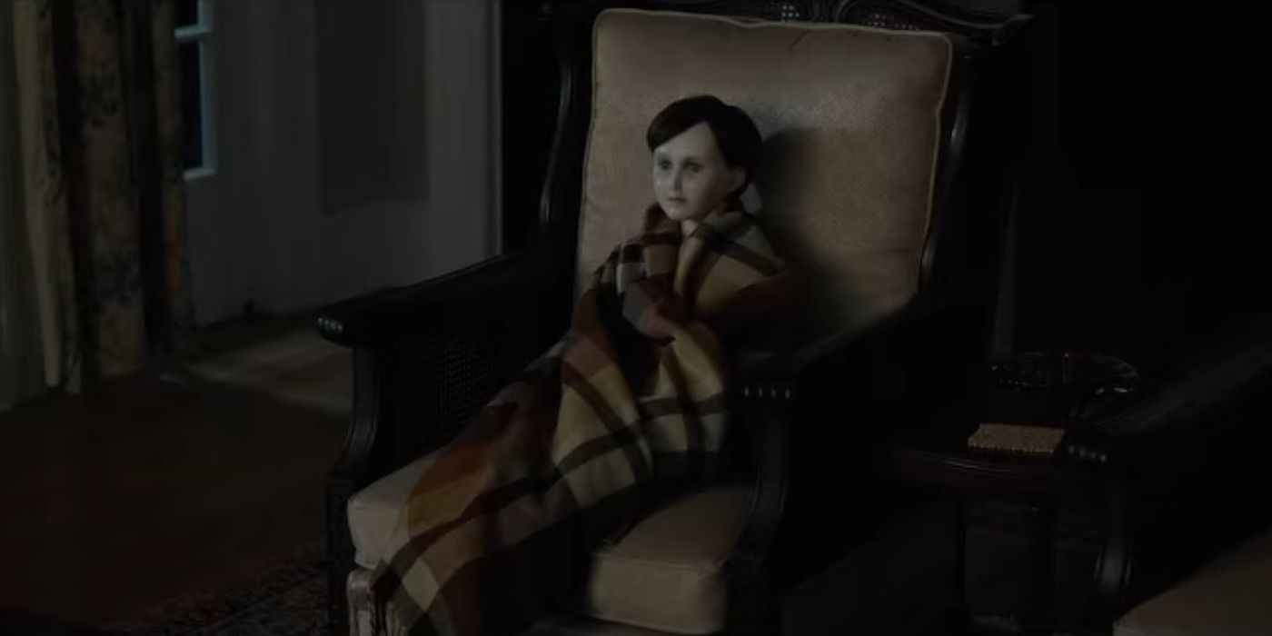 Brahms, the doll, sits in a chair in Brahms: The Boy II.